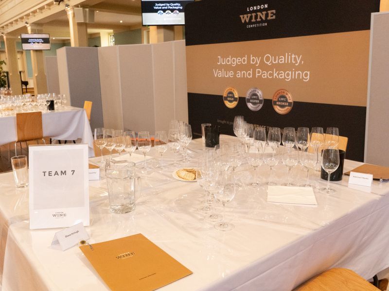 Each table has 3 judges, 10 wine glasses, one folder